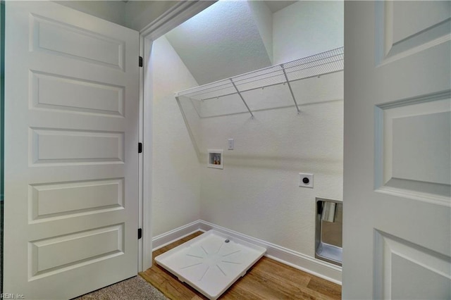 washroom featuring baseboards, hookup for a washing machine, wood finished floors, hookup for an electric dryer, and laundry area
