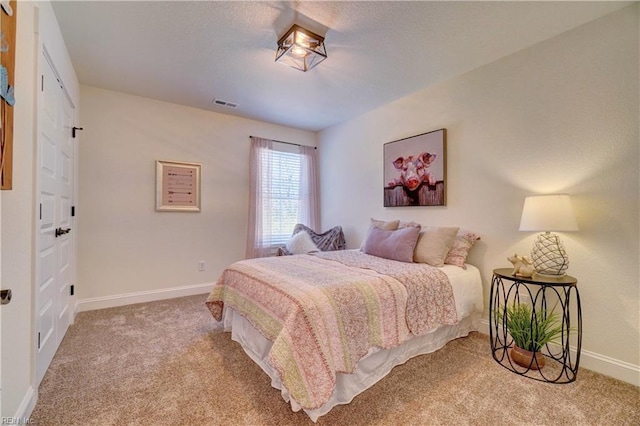 bedroom featuring visible vents, baseboards, and carpet floors