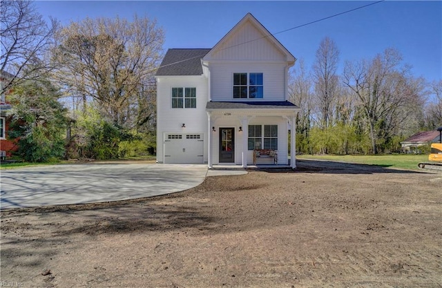 view of front facade with covered porch, board and batten siding, an attached garage, and driveway