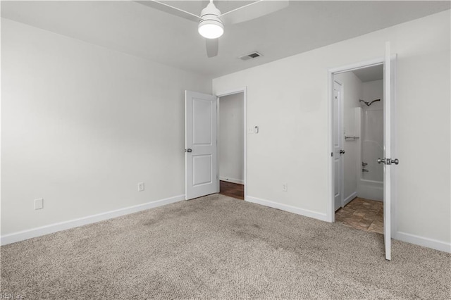 unfurnished bedroom with carpet flooring, baseboards, a ceiling fan, and connected bathroom