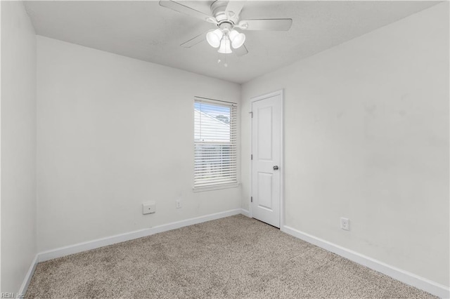 spare room featuring carpet floors, baseboards, and ceiling fan