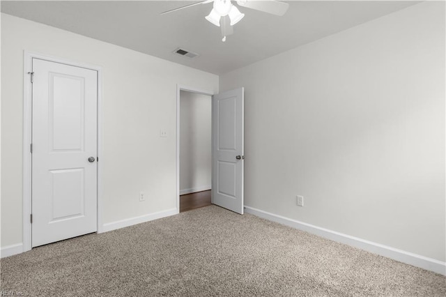 unfurnished bedroom featuring carpet, baseboards, and ceiling fan