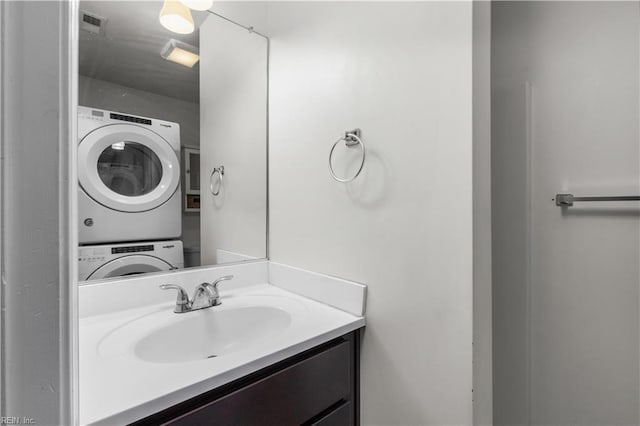 bathroom with estacked washer and dryer and vanity