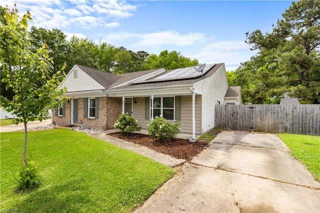 view of front of property featuring solar panels, a shingled roof, concrete driveway, and covered porch