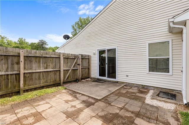 rear view of house featuring a patio and fence