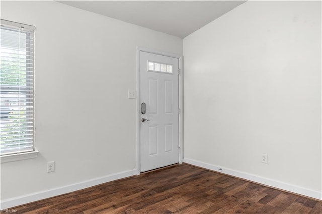 entrance foyer with dark wood finished floors and baseboards