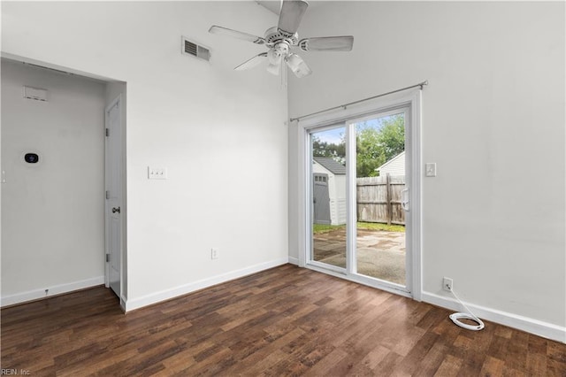 unfurnished room with ceiling fan, wood finished floors, and baseboards