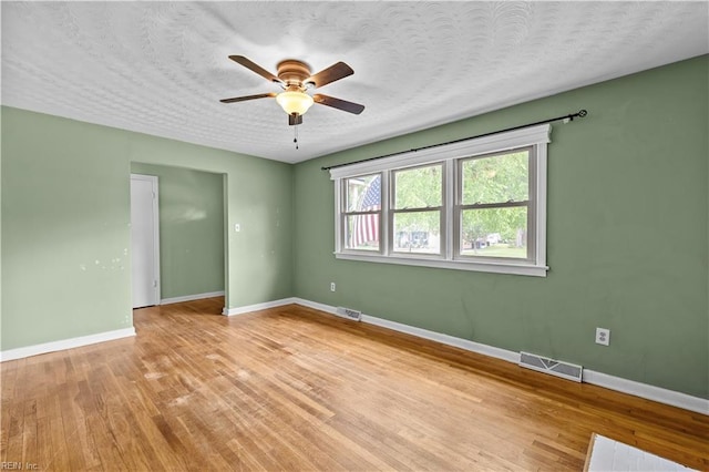 209 Jarvis Rd, Chesapeake, VA 23323 - empty room with light wood-style flooring, baseboards, a ceiling fan, and a textured ceiling