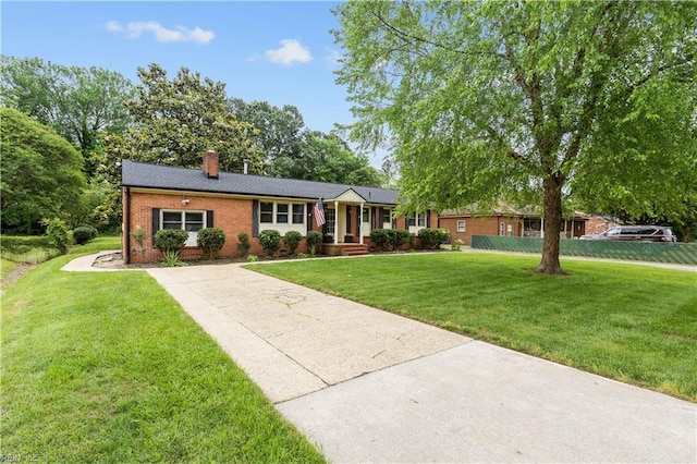 209 Jarvis Rd, Chesapeake, VA 23323 - single story home featuring a front yard, a chimney, brick siding, and concrete driveway