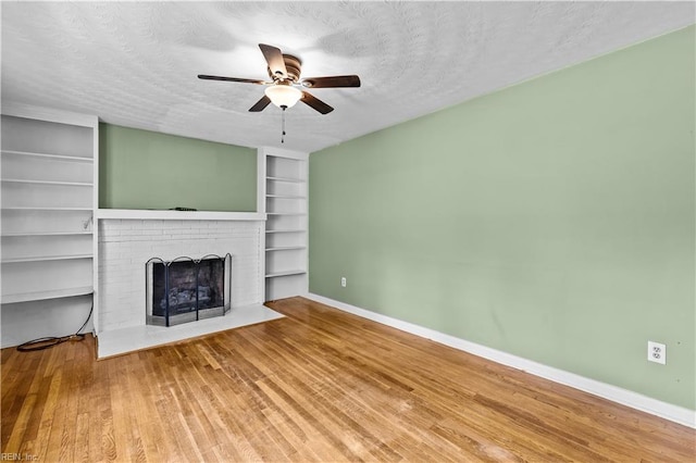 209 Jarvis Rd, Chesapeake, VA 23323 - unfurnished living room with built in shelves, a fireplace, wood finished floors, ceiling fan, and baseboards