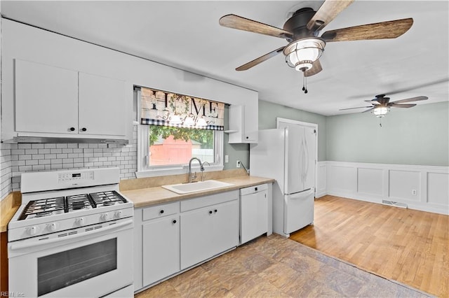 209 Jarvis Rd, Chesapeake, VA 23323 - kitchen featuring white appliances, a sink, a ceiling fan, under cabinet range hood, and light countertops