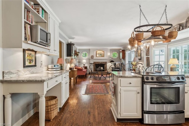 kitchen featuring stainless steel range with electric stovetop, white cabinetry, and dark wood-style floors