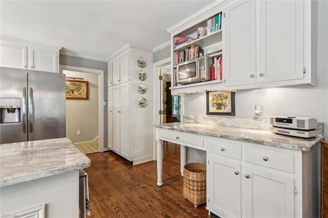 kitchen featuring stainless steel fridge, white cabinetry, dark wood finished floors, crown molding, and light stone counters