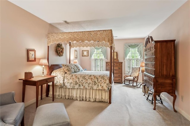 carpeted bedroom with access to outside and baseboards