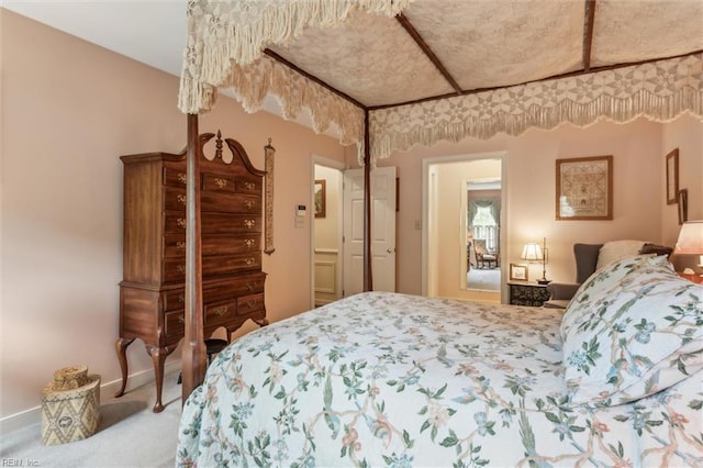 bedroom featuring carpet floors and baseboards