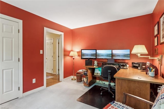 carpeted home office with baseboards