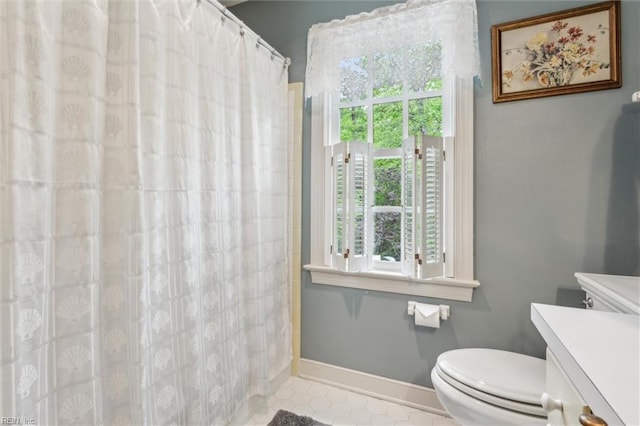full bath with toilet, tile patterned floors, baseboards, vanity, and a shower with curtain
