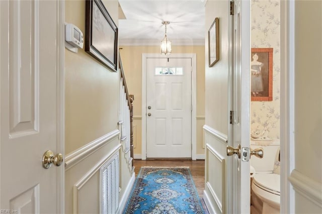 doorway featuring wood finished floors and wallpapered walls