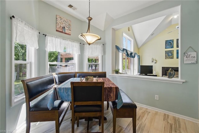 dining area with vaulted ceiling, baseboards, wood finished floors, and a ceiling fan
