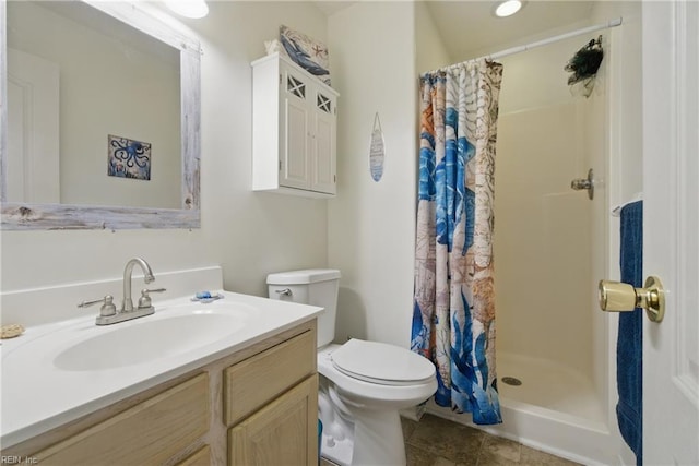 bathroom with toilet, a stall shower, vanity, and tile patterned flooring