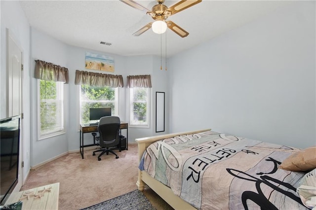 bedroom with carpet flooring, multiple windows, baseboards, and an office area