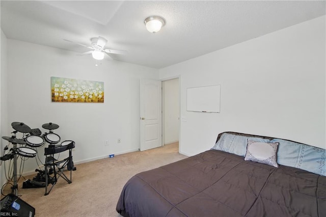 carpeted bedroom featuring baseboards and a ceiling fan