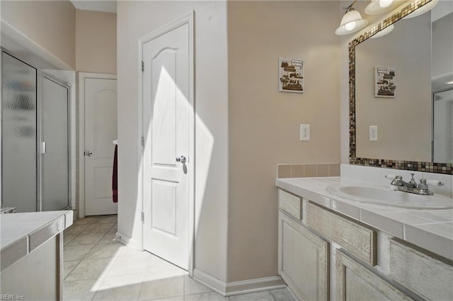 bathroom featuring a shower stall, vanity, and tile patterned flooring