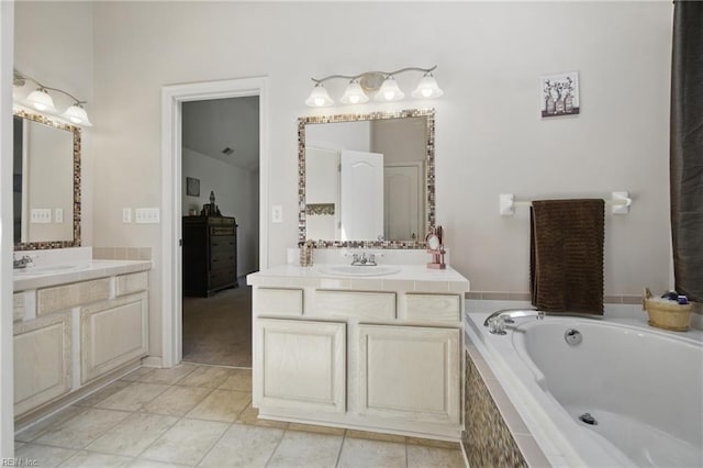 full bathroom with a garden tub, two vanities, and tile patterned floors