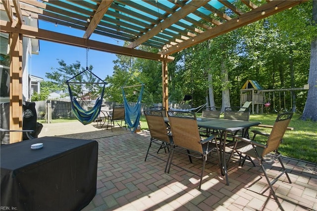 view of patio / terrace featuring outdoor dining area, a pergola, and a playground