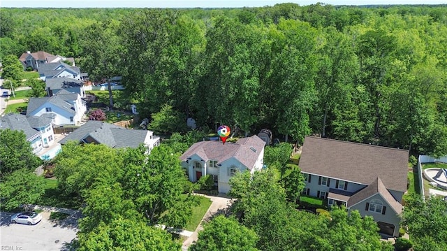 aerial view of residential area with a heavily wooded area