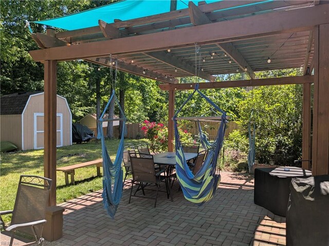 view of patio featuring a storage unit, outdoor dining space, an outdoor structure, and a pergola