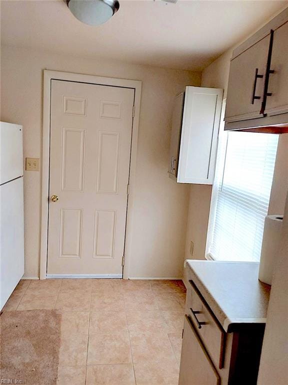 938 Ivy Ave, Newport News, VA 23607 - kitchen with freestanding refrigerator, healthy amount of natural light, light tile patterned floors, and light countertops