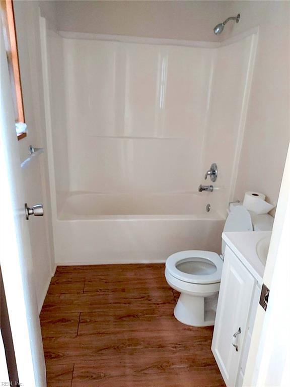 938 Ivy Ave, Newport News, VA 23607 - bathroom with toilet, shower / bathtub combination, wood finished floors, and vanity