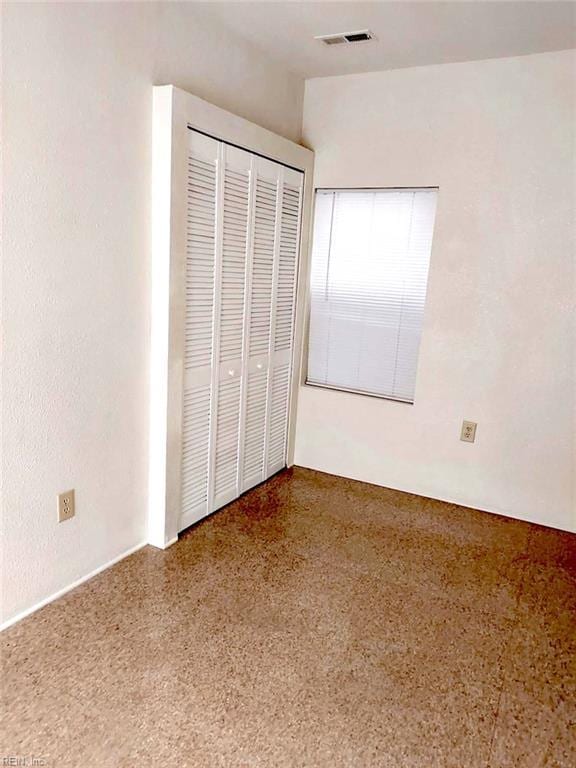 938 Ivy Ave, Newport News, VA 23607 - unfurnished bedroom featuring speckled floor and a closet