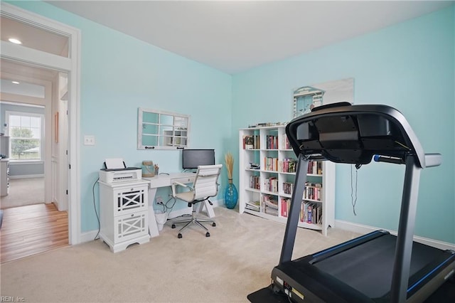 carpeted office space featuring baseboards