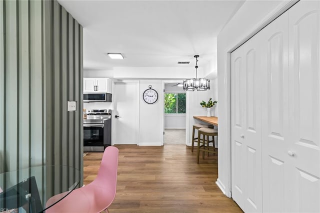 728 23rd St, Newport News, VA 23607 - corridor with a notable chandelier, baseboards, visible vents, and wood finished floors
