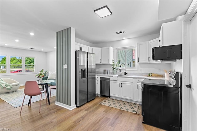 728 23rd St, Newport News, VA 23607 - kitchen featuring a sink, visible vents, light wood-style flooring, light countertops, and appliances with stainless steel finishes