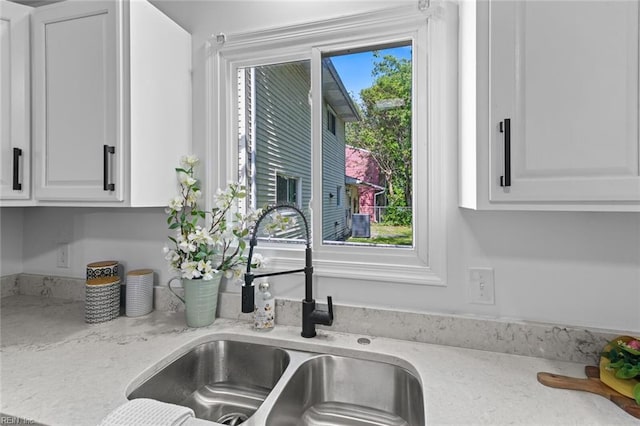 728 23rd St, Newport News, VA 23607 - interior details featuring white cabinetry, light stone counters, and a sink
