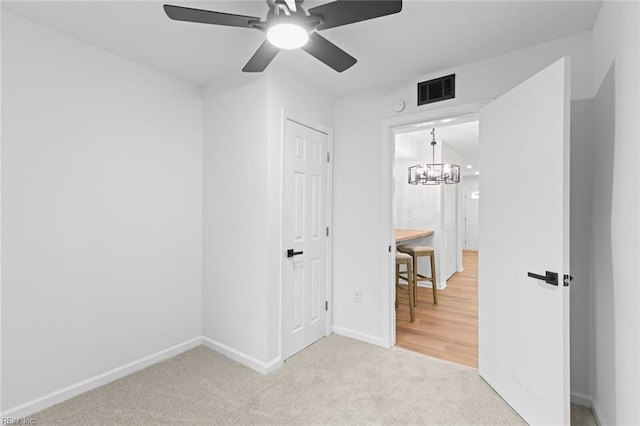 728 23rd St, Newport News, VA 23607 - unfurnished bedroom with carpet, visible vents, baseboards, and ceiling fan with notable chandelier