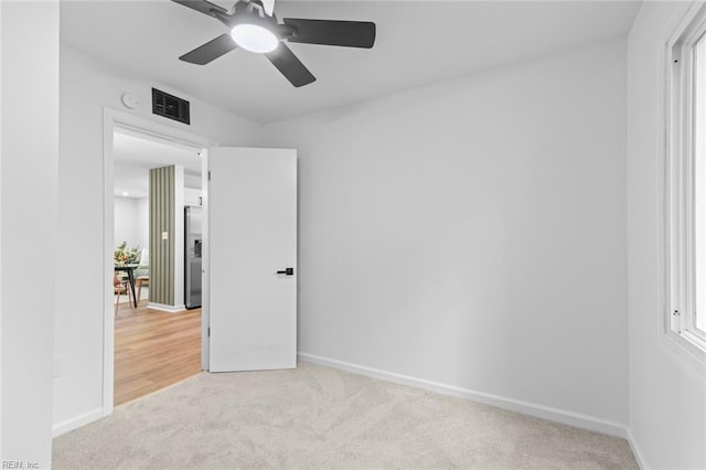 728 23rd St, Newport News, VA 23607 - unfurnished bedroom featuring carpet, visible vents, stainless steel fridge, a ceiling fan, and baseboards