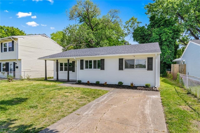 728 23rd St, Newport News, VA 23607 - split level home featuring a front yard, brick siding, and fence