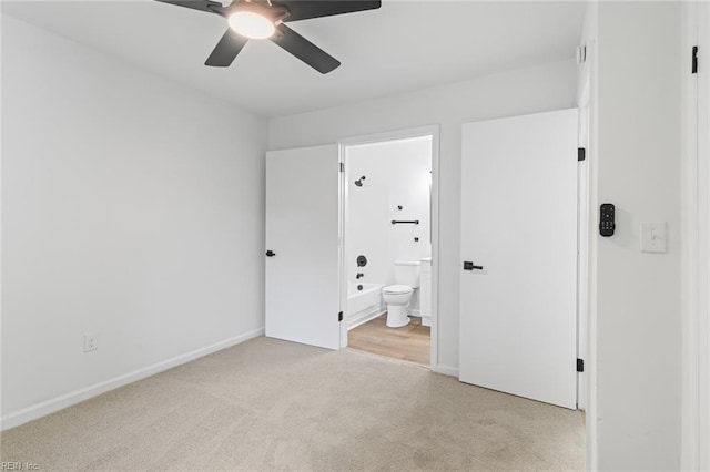 728 23rd St, Newport News, VA 23607 - unfurnished bedroom featuring light colored carpet, ensuite bathroom, baseboards, and ceiling fan