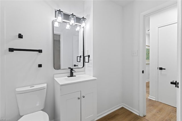 728 23rd St, Newport News, VA 23607 - bathroom with toilet, baseboards, wood finished floors, and vanity