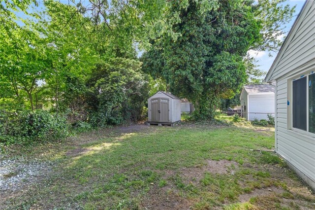 728 23rd St, Newport News, VA 23607 - view of yard with a storage shed, an outbuilding, and fence