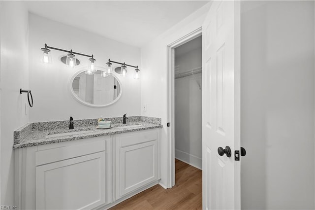 325 S Main St, Suffolk, VA 23434 - bathroom featuring a sink, double vanity, and wood finished floors