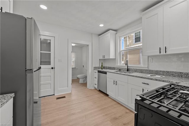 325 S Main St, Suffolk, VA 23434 - kitchen with a sink, visible vents, plenty of natural light, white cabinets, and appliances with stainless steel finishes