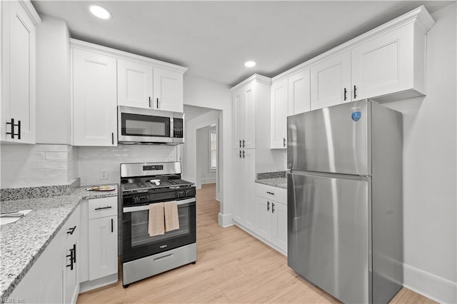 325 S Main St, Suffolk, VA 23434 - kitchen featuring recessed lighting, white cabinetry, backsplash, stainless steel appliances, and light wood-type flooring