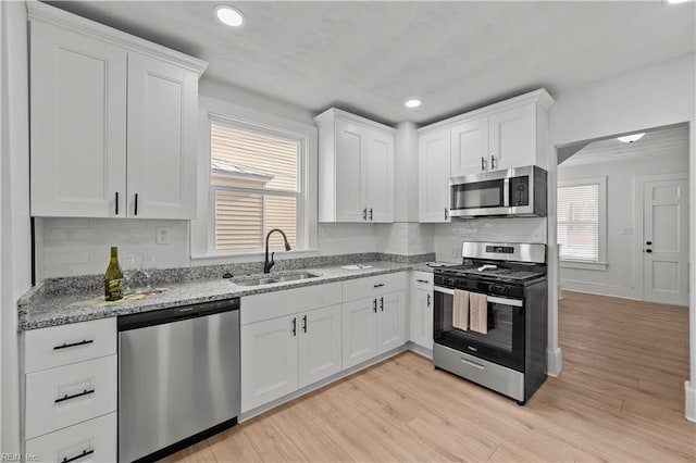 325 S Main St, Suffolk, VA 23434 - kitchen featuring a sink, stainless steel appliances, white cabinets, and light stone countertops