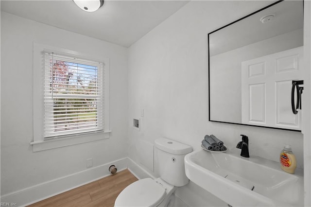 325 S Main St, Suffolk, VA 23434 - half bathroom featuring toilet, wood finished floors, baseboards, and a sink