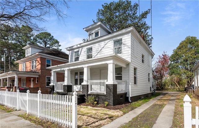 325 S Main St, Suffolk, VA 23434 - american foursquare style home with driveway, covered porch, fence, and crawl space